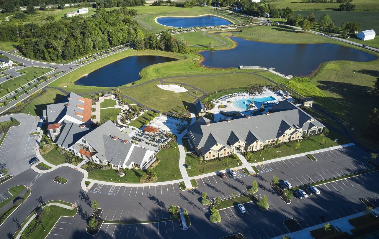 Birds-eye view of Amblebrook amenities and Great Lawn area, with view of lakes and grass.