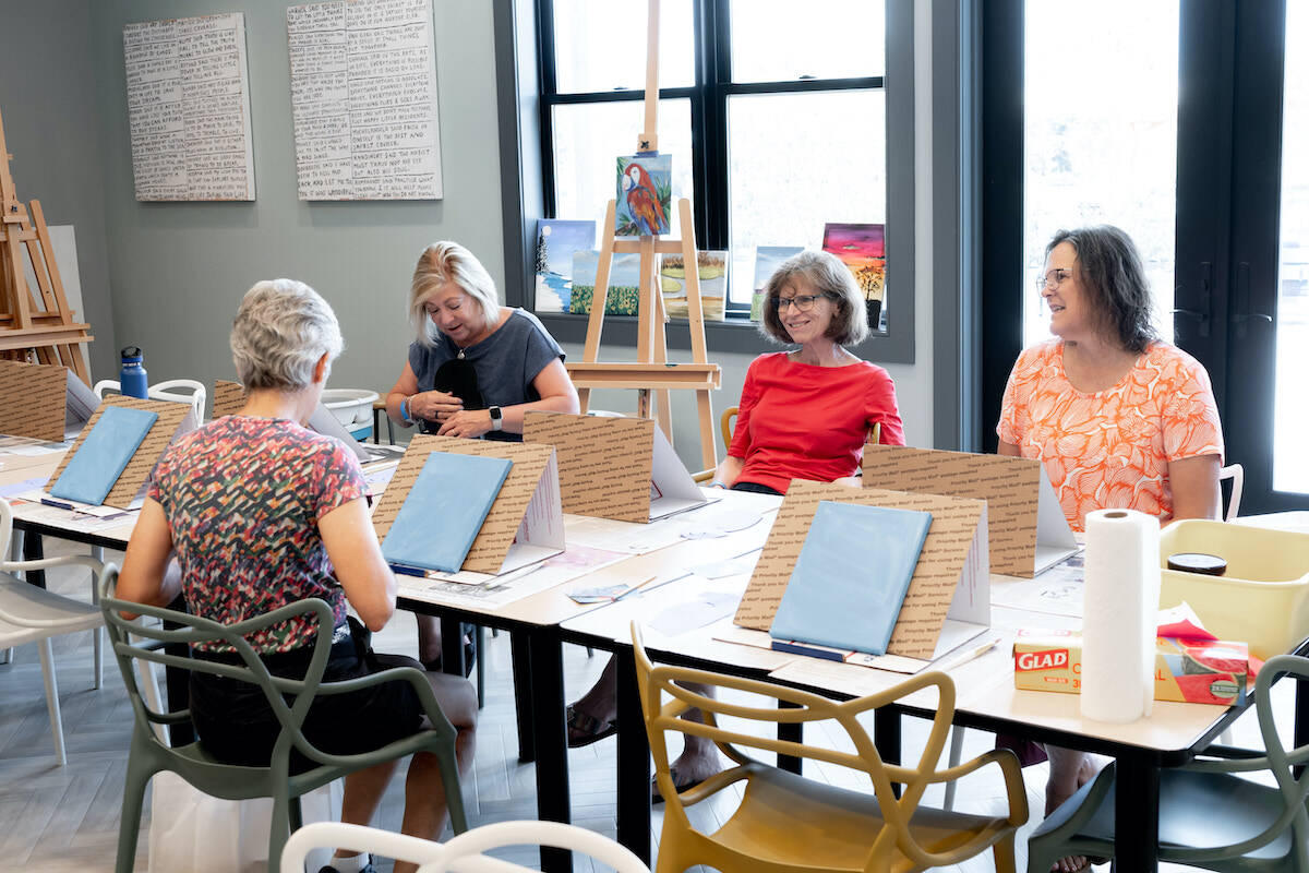 Four active adults taking a painting class at Amblebrook.
