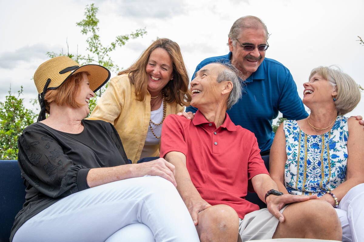Amblebrook residents enjoying an evening outdoors sitting together.