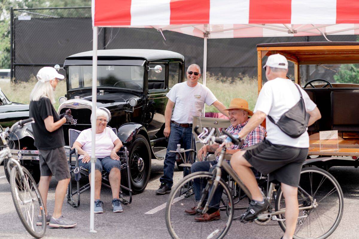 Group of Amblebrook residents enjoying time together at a car show hosted by Amblebrook. 