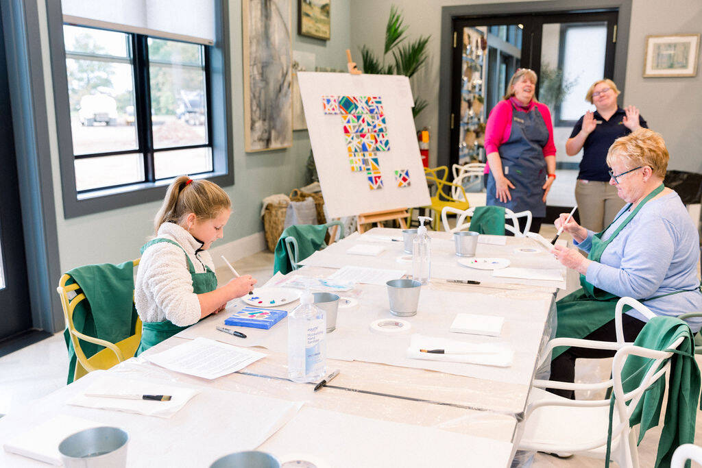 Grandkid painting with grandma at Amblebrook