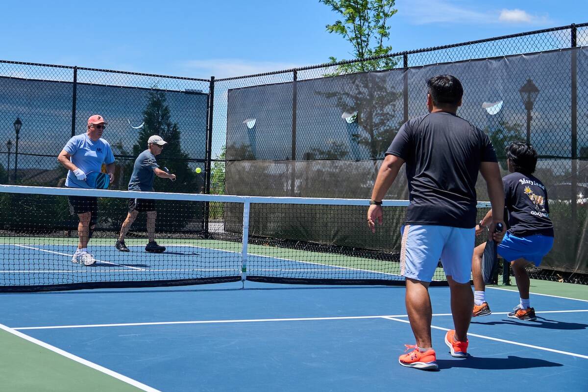 Amblebrook residents and their family playing pickleball in the outdoor court.